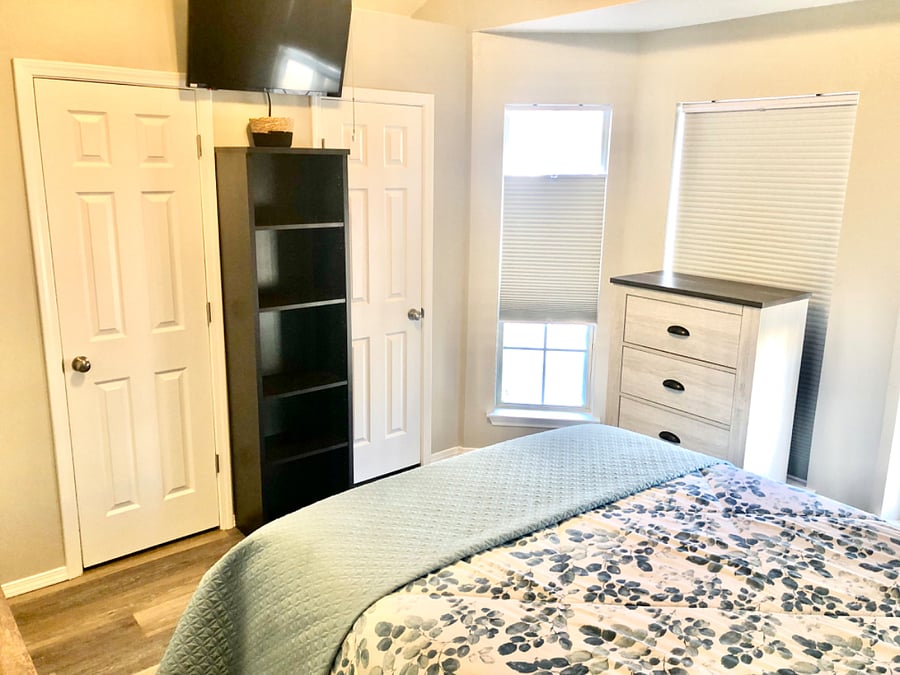 Bedroom #2 with queen bed, nightstand, dresser, chest, smart tv and closets