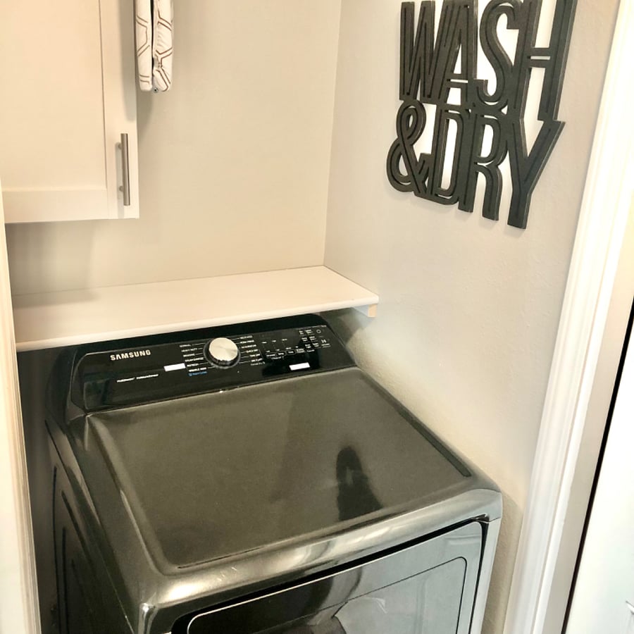 Xl dryer. Dryer sheets provided. Iron and iron board located above dryer