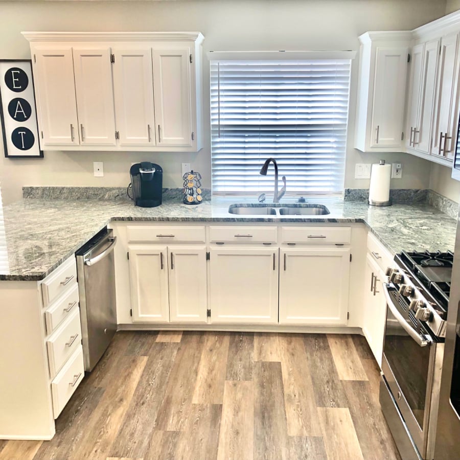Kitchen with granite countertops, garbage disposal and Keurig coffee maker. Coffee pods, sweeteners and creamers provided. Kitchen is fully stocked with, pots/pans dishes and utensils
