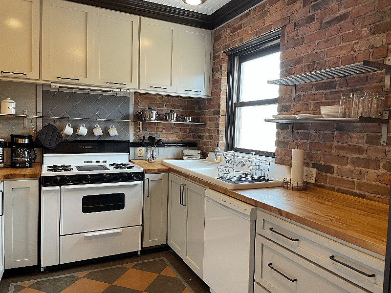 Kitchen with gas stove, vintage sink and butcher block countertops