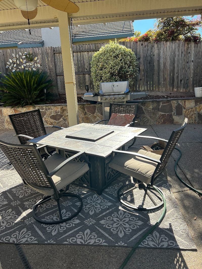 Fire pit with patio cover. Drop down shades to keep out sun/wind.