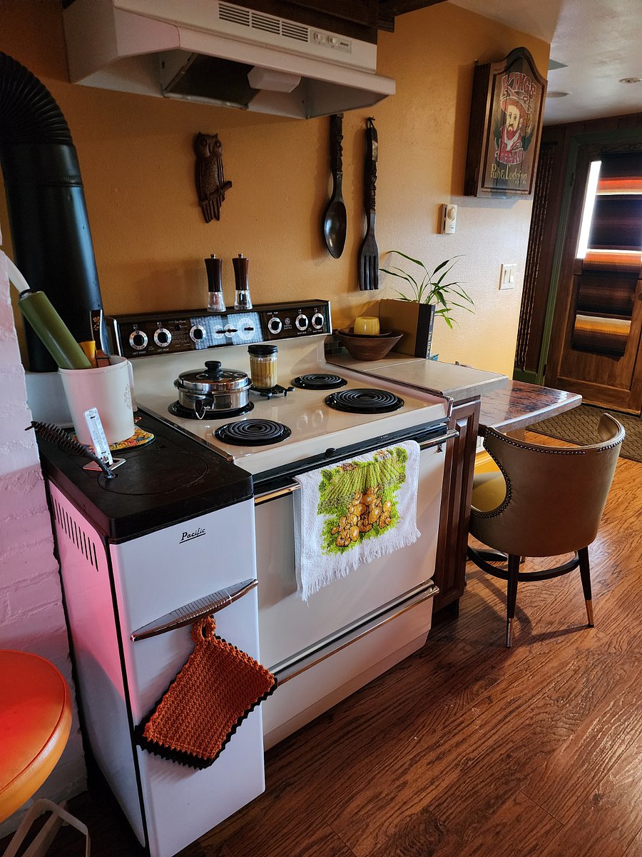 Original 1940's wood stove still stands as a testament to the homes origins. Era correct 1970's stove is ready to bake a pizza or cook your morning eggs.