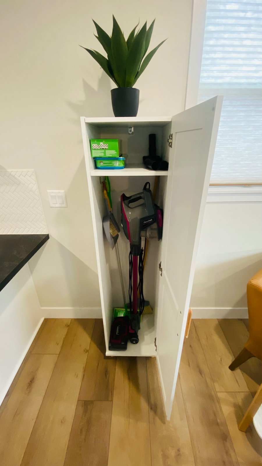 Vacuum, broom, dustpan, and swiffter in a convenient cabinet.