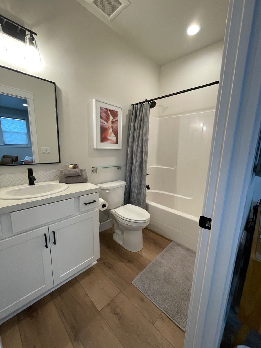 Private bathroom with its own dedicated hot water heater. Shower/tub combo with removable nonslip mat for tub, toiletries, hairdryer, towels (including hair towel), two bath mats, cleaning supplies, and First Aid Kit.
