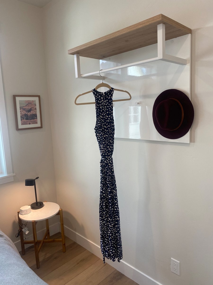 Extra hanging space for clothes, with hooks and a shelf.