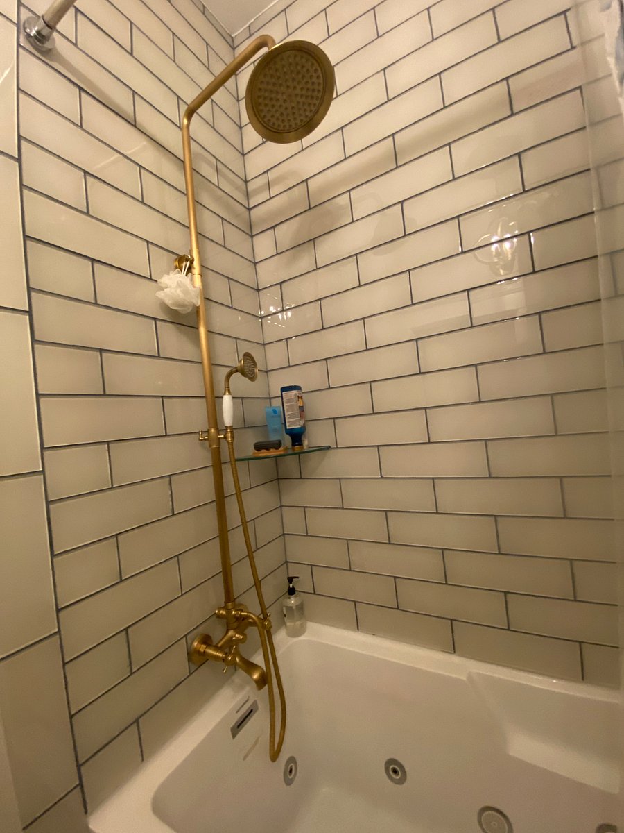 Gold Spa Bath with jetted tub and rain shower.