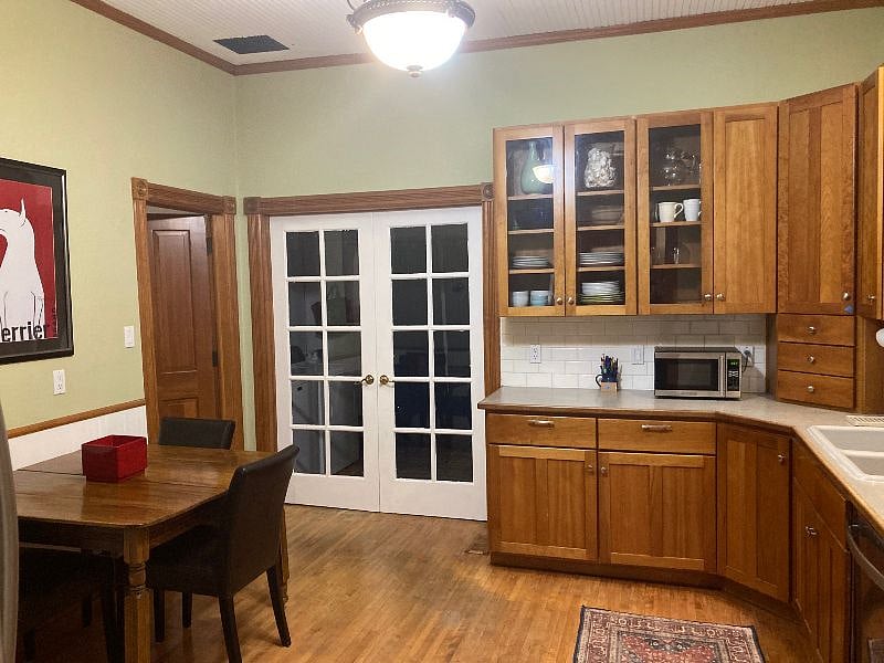 French doors lead to laundry room with easy access to private back yard and gas grill