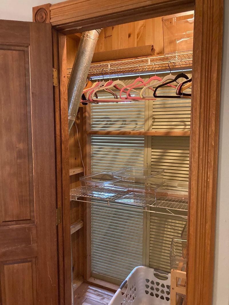 Master bedroom closet with plenty of hanging space, shelves, and shoe rack