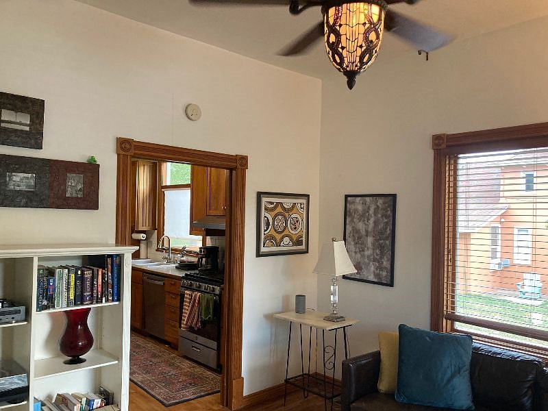 Cozy living room with high ceiling and huge windows