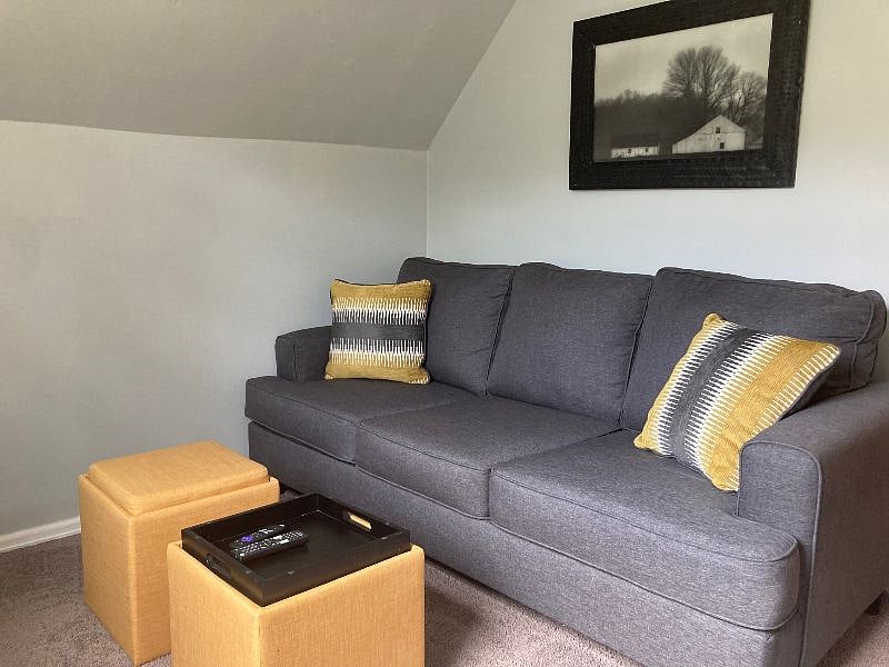 Third bedroom set up with sofa bed and wall-mounted flat screen TV