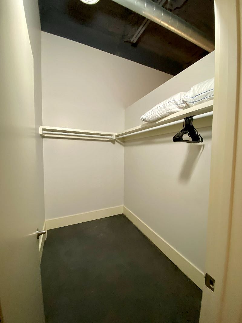 Primary closet - plenty of space! Also includes tall chest of drawers and shoe rack.