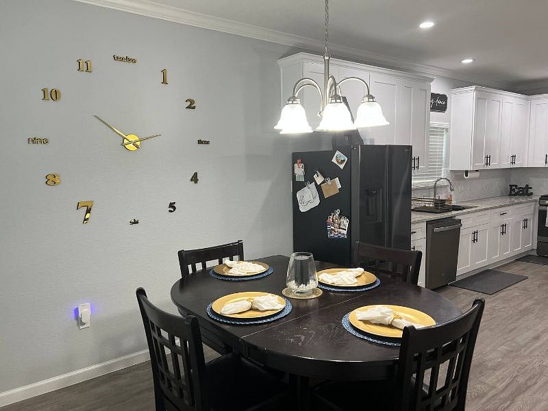 Dining room table just off kitchen to enjoy your meals with view of living room television.