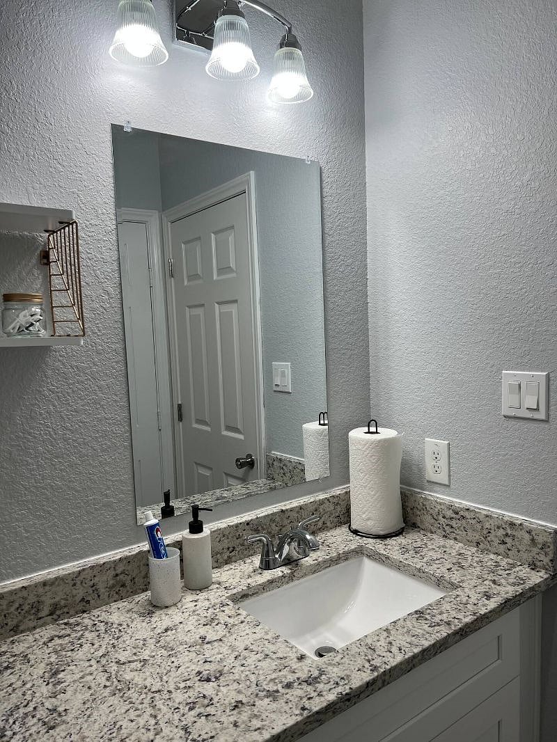 Large, well lit mirror space with toiletries.