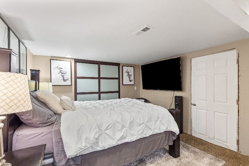 Basement bedroom. 75 inch televison plus bathroom and shower. 