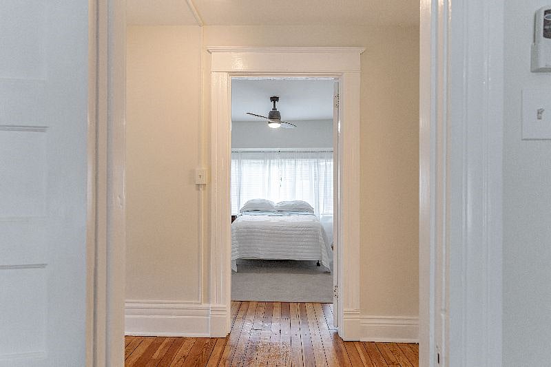 Bedroom #2 on 2nd floor/front end of house with 3 light sliding windows overlooking street.