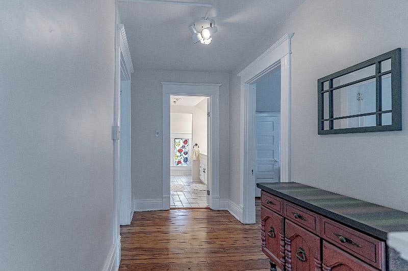 At the top of the stairwell landing of 2nd floor. Straight ahead is a full bath (soaker tub and excellent lighting for makeup application or the such). To the left you will find a 2nd bedroom and to the right you will find a 3rd bedroom.