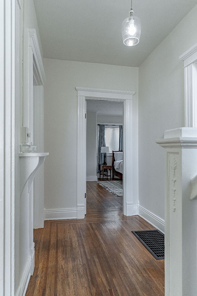 1st floor hallway looking in to primary bedroom. Kitchen doorway is to the right in this photo as is the stairwell leading to upstairs.