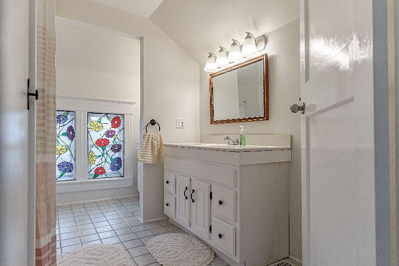 Two vanity sinks in this bathroom. Other vanity sink is behind small separating wall straight ahead in this photo.