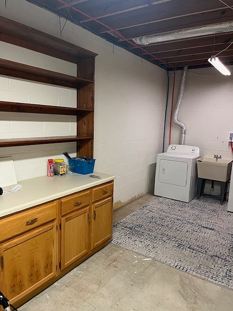 Washer/dryer, storage cabinet, and extra storage available in adjacent garage area