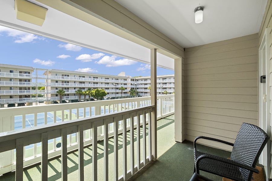 Front porch with 2 chairs overlooking tennis courts