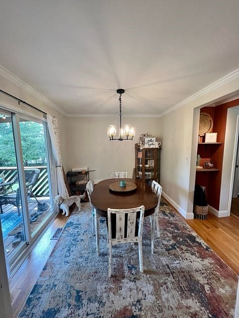Dining room with sliding glass door to large deck and fenced in backyard.
