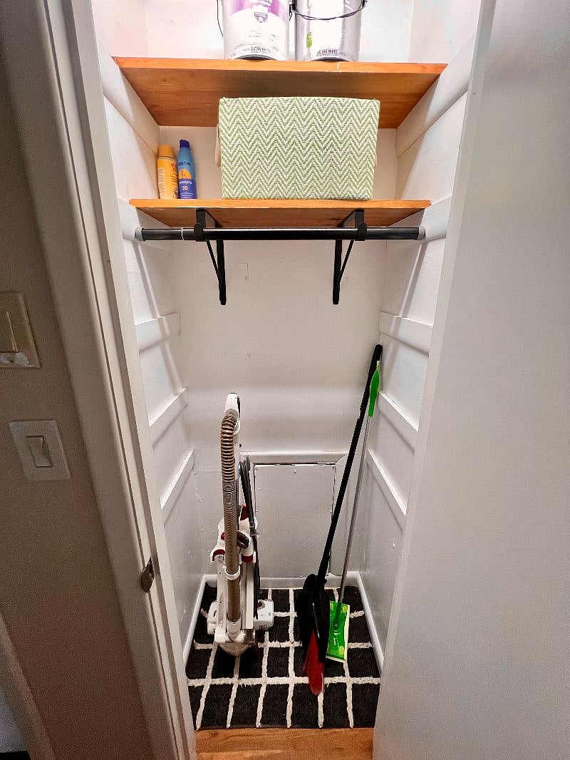 Hallway closet with cleaning supplies and extra storage