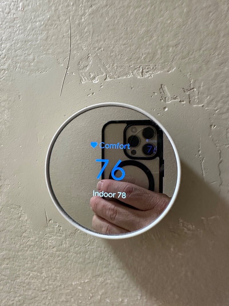 Google Neat thermostat in the hallway.
