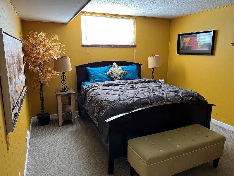 This is the second bedroom. Cozy bedding, two closets, three windows for plenty of light.