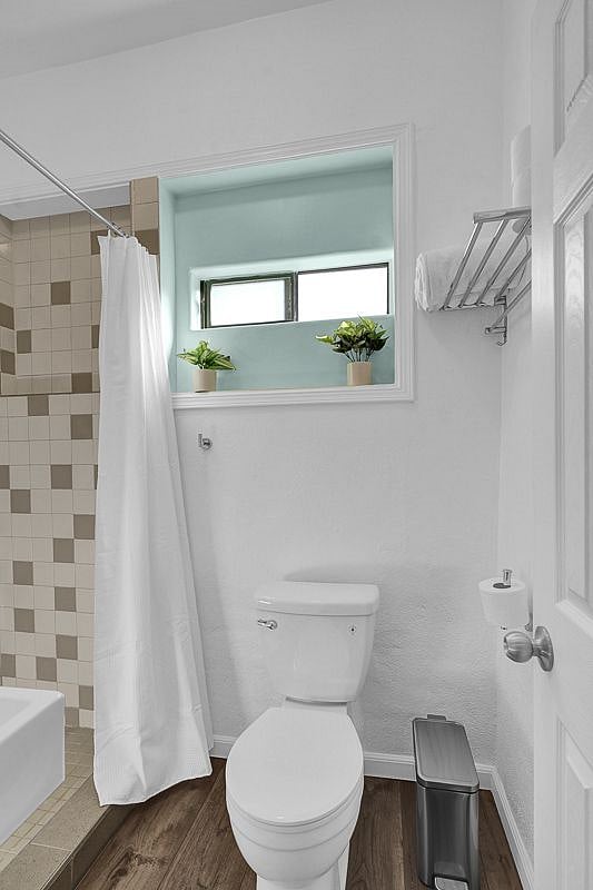 Full sized shower (no bumping elbows) with shampoo, conditioner and bodywash dispenser. Toilet with bidet toilet seat and window for fresh air and sunshine.