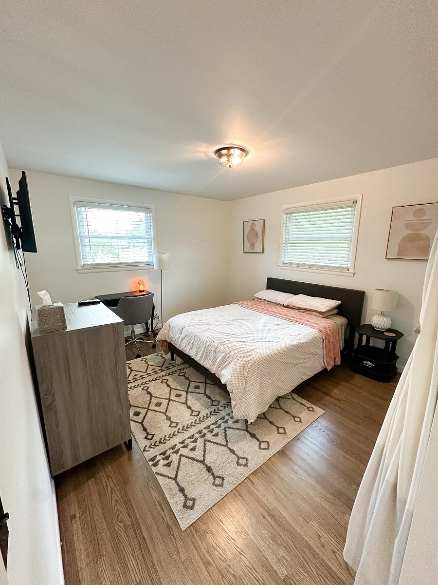Main bedroom with full closet, queen bed, desk, dresser and Smart TV
