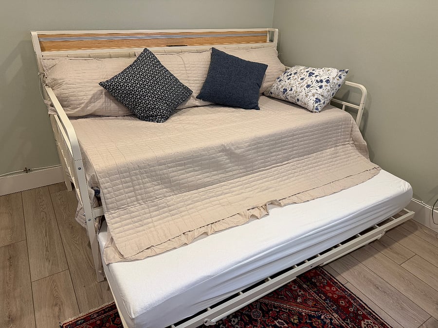 Daybed pops up and can be made into one queen bed or separated and become 2 twin beds in this room.