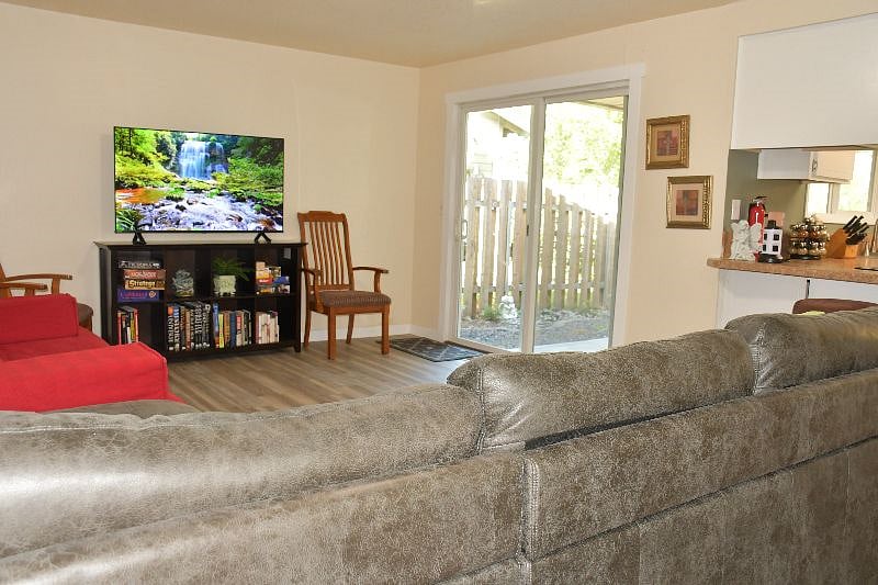 Family room with a queen sized futon, large smart TV, books, games, and toys.