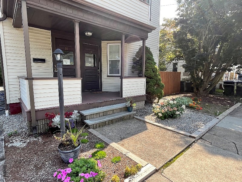 Inviting entry with porch. One dedicated free parking space on premises.