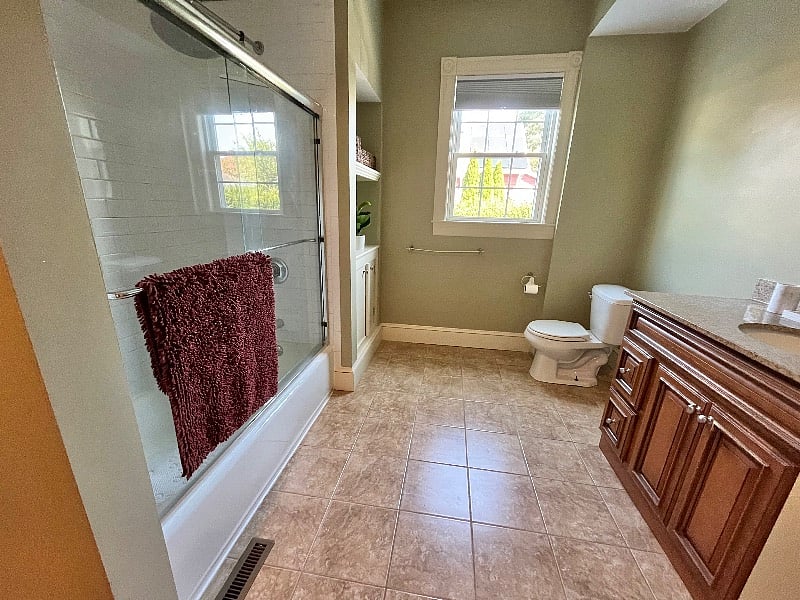 Super-sized bathroom with rain shower makes getting ready for the day a breeze.