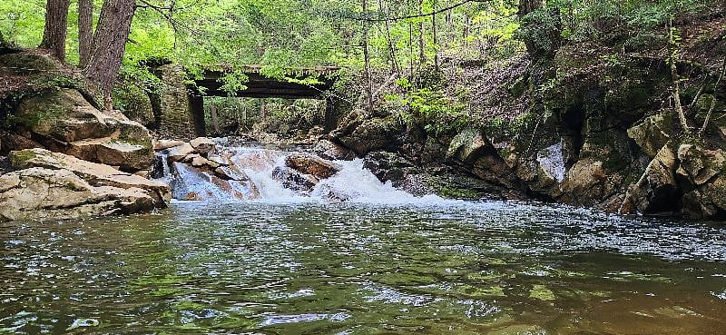 Showing the waterfalls large pool below our private bridge, 3 min walk from the retreat cottage. You can wade in gradually and then dive into the deep end that is just under 6' deep. The water is crystaline clear and super charged with oxygen from upstream waterfalls.