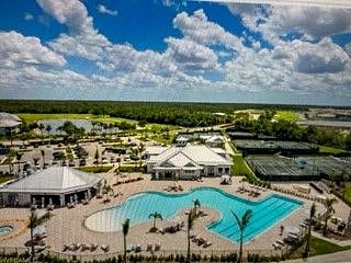 Resort pool with tiki bar, fitness center, pickleball and tennis courts