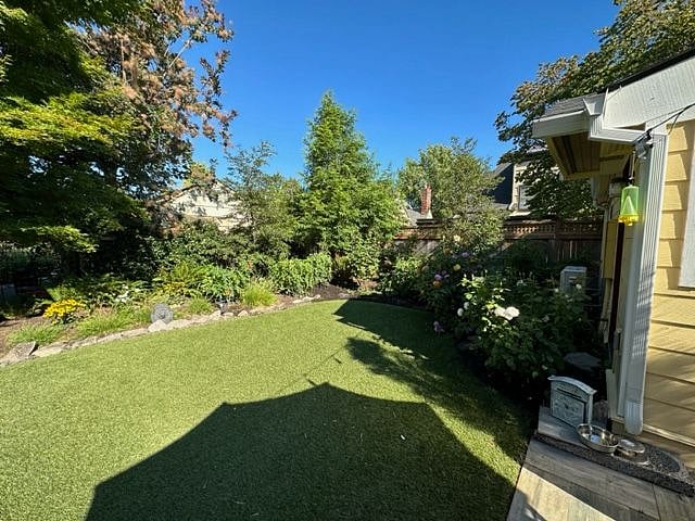 Backyard shared with back of house apartment with beautiful trees and shrubs for security and privacy.