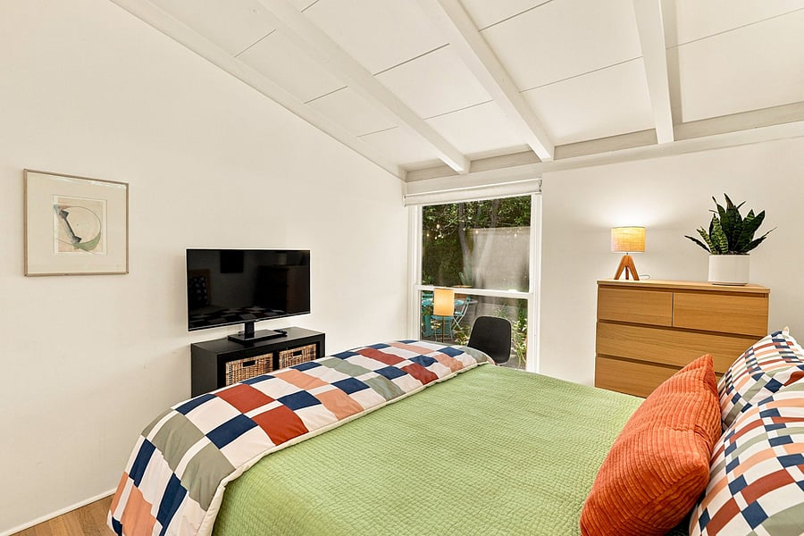 Get cozy in the queen bed to stream your favorite programs on the Roku TV. A power station to charge electronics is located on the table by the window.