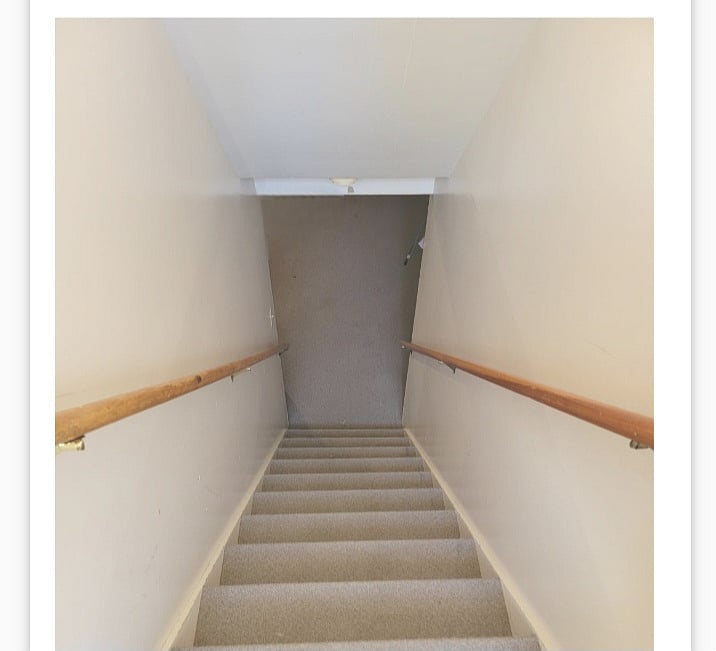 Stairs leading to laundry room