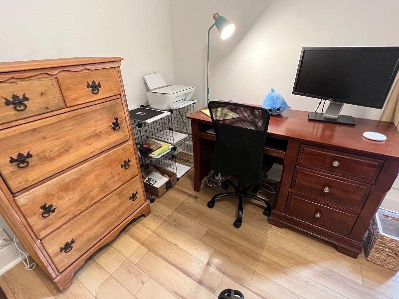 Home office corner in Bedroom 2 with printer, desk, storage, monitor