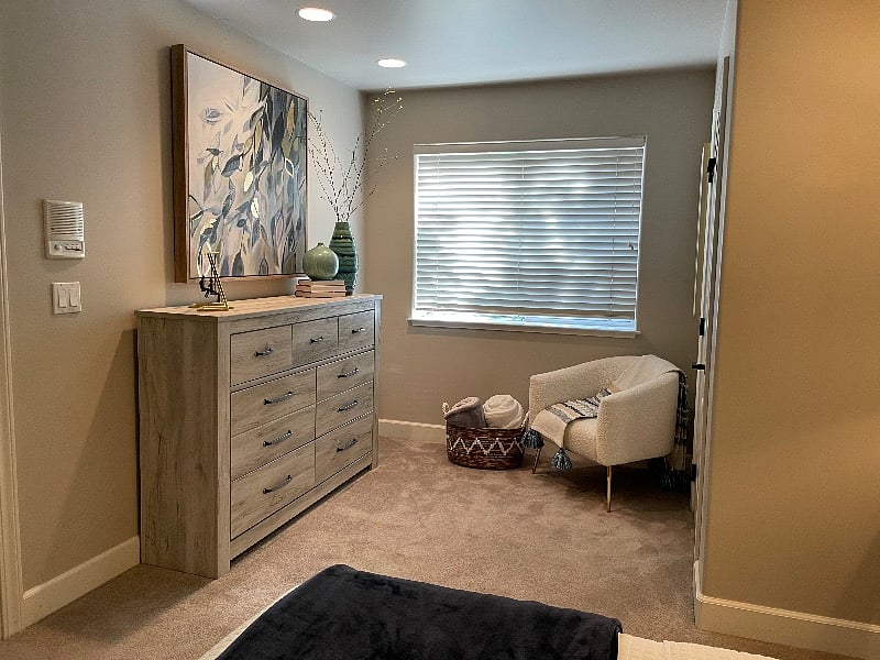 Dresser to store your things. A chair with small table and a charger.