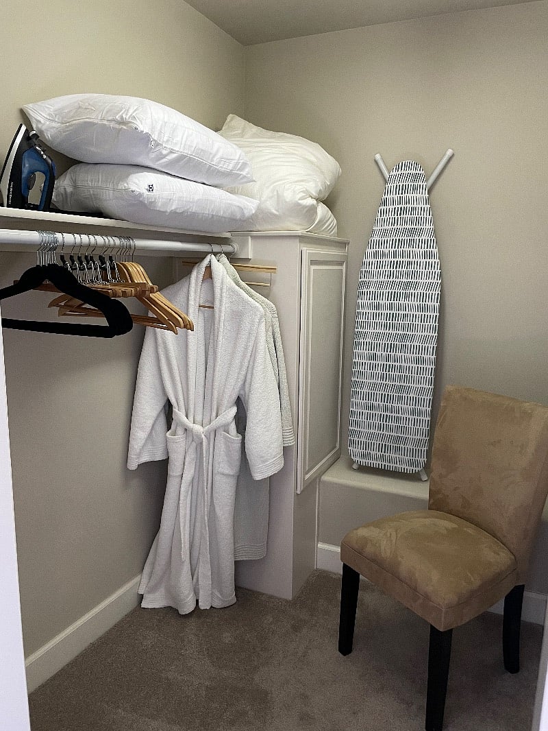 Walk-in closet, ironing board and iron, hangers etc.