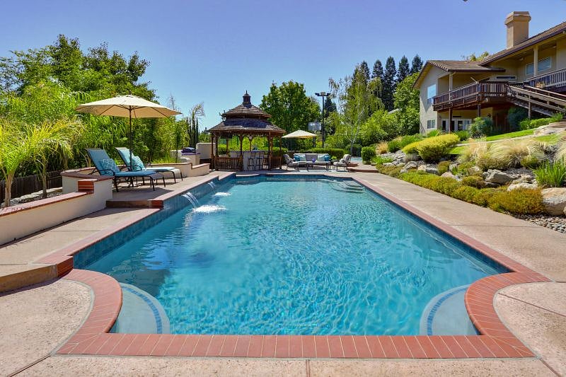 Pool and cabana with outdoor kitchen you may use the barbeque out there.