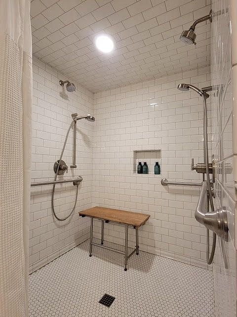 Tiled shower with four shower heads and Starter Bathroom Kit