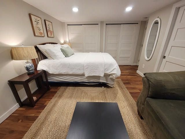 The far wall is all closet space of mostly hanging storage, but also two sizeable floor-to-ceiling shelves.