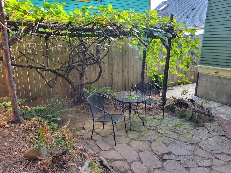 Patio. We've been told the grapevine is a 95 year old Depression-era vine. Every few houses still have their vine, we like to spot them on walks. We get great mini table grapes at summer's end that taste like purple drank Starbursts.