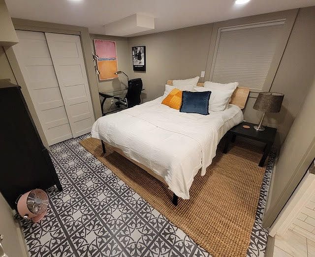 The smaller bedroom has a desk, dresser, and closet hanging storage.