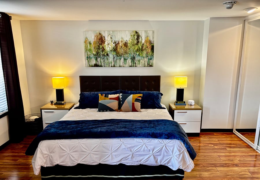 King bed with newer mattress and bedding.