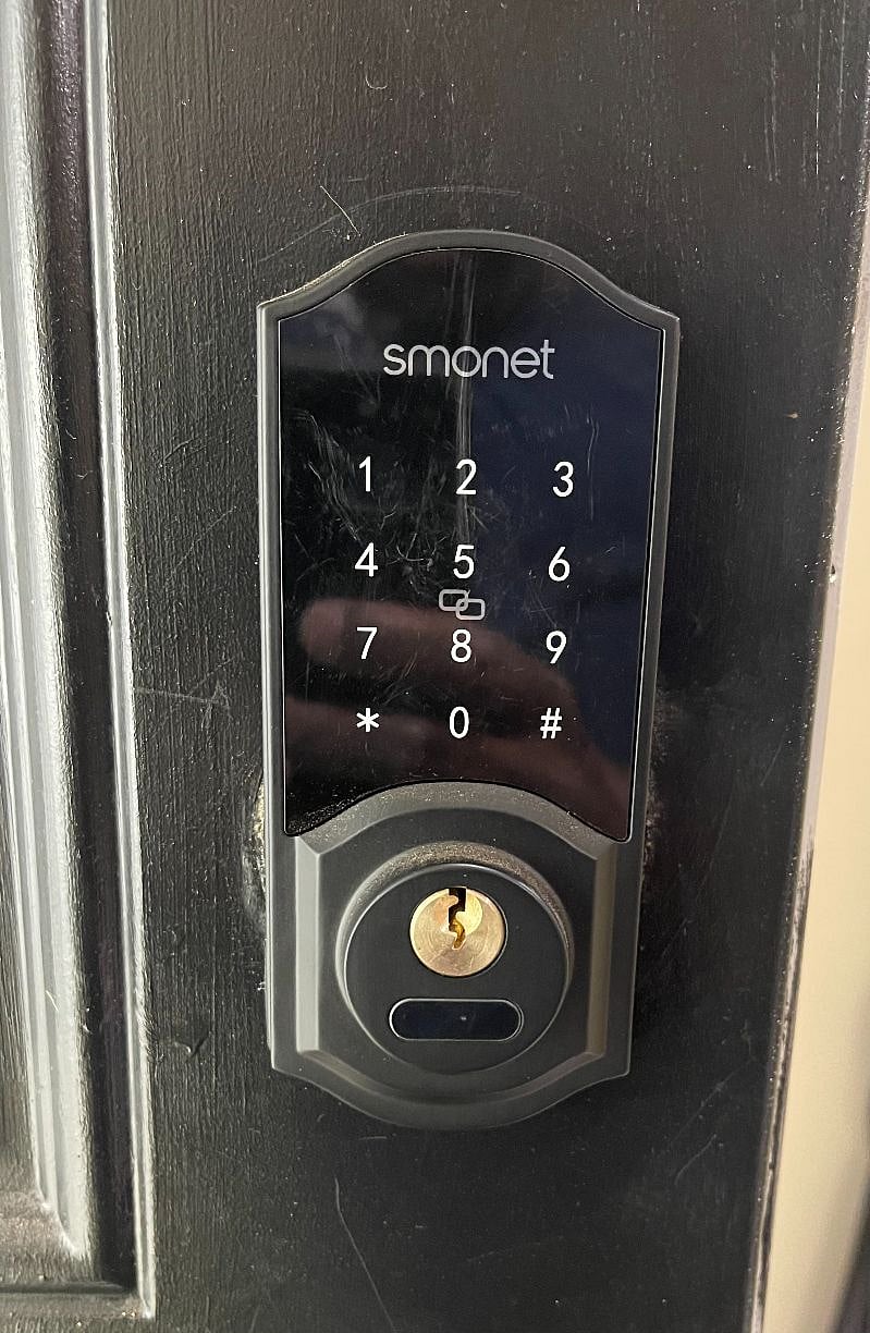 Front door equipped with a smart lock for secure, keyless entry.