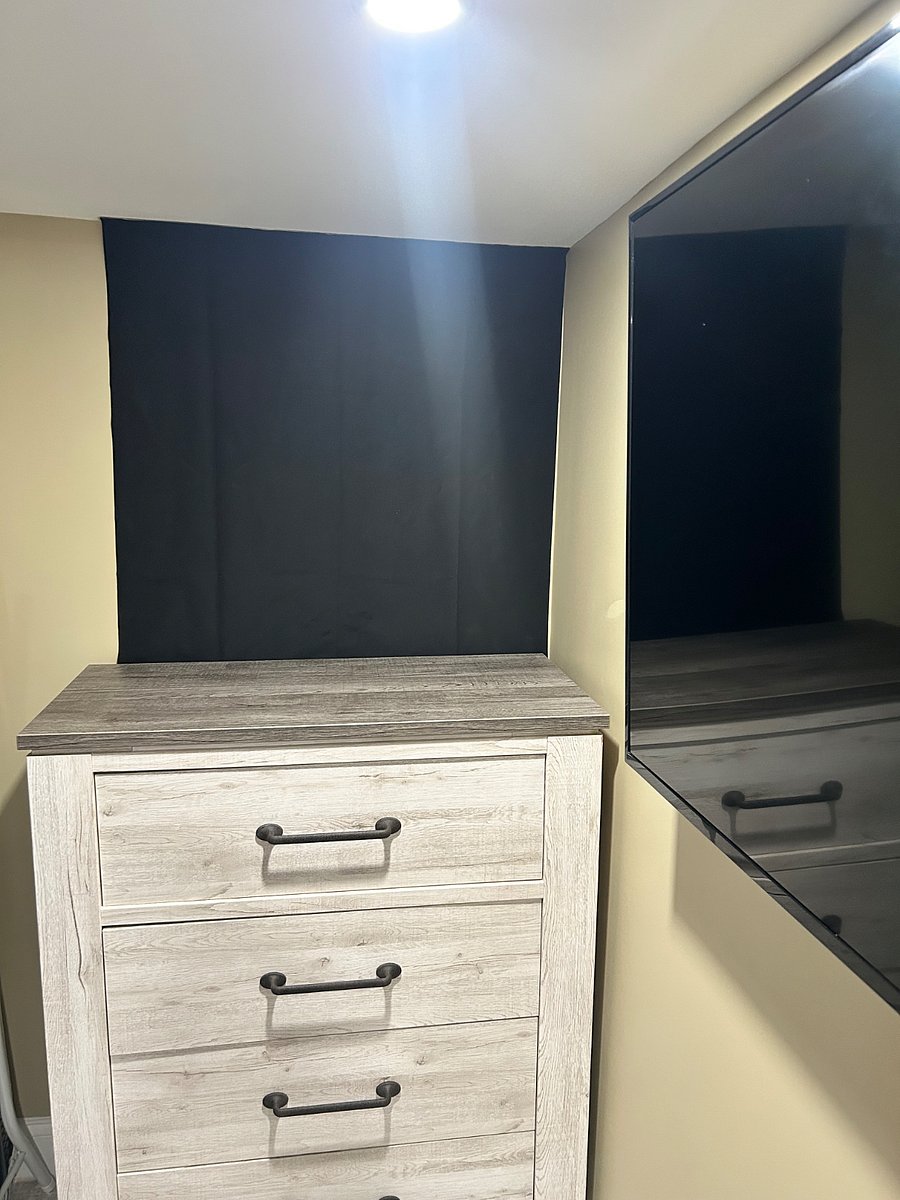 The bedroom features blackout curtains for added comfort.